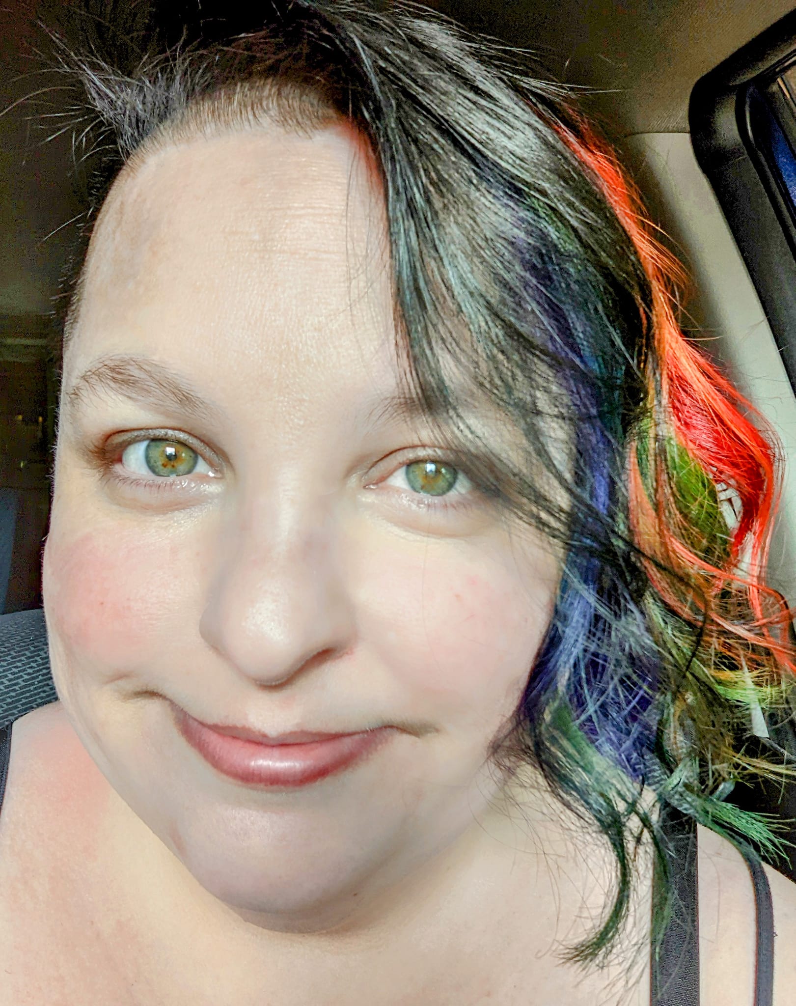 Author and artist Raven Oak with rainbow colored hair.