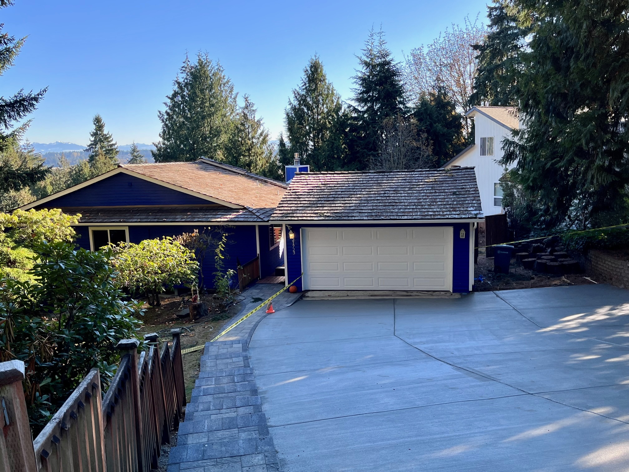 Our house with new blue colored paint, new driveway, and new paver stones