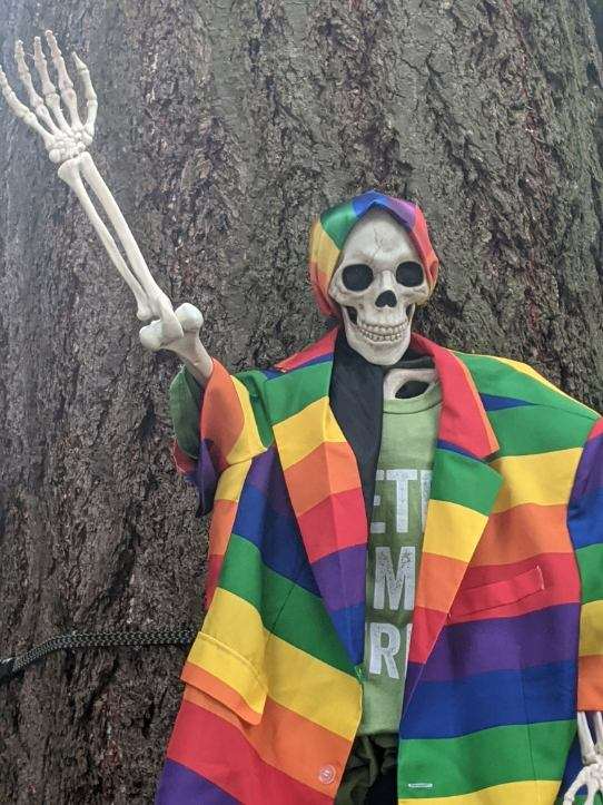 Pride Skeleton wearing a rainbow colored suit