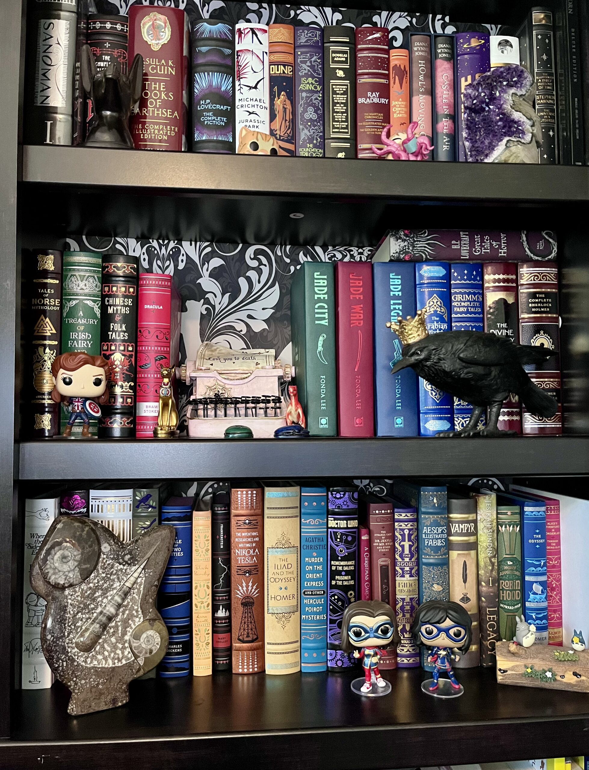 Picture of a black bookcase featuring gorgeous book spines.