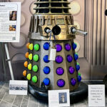 A rainbow colored Dalek named Clara, built by the late Shaylee Bell and featured at WorldCon Seattle 2025.